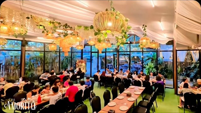 Full indoor dining hall at Casa Amorito with all tables filled